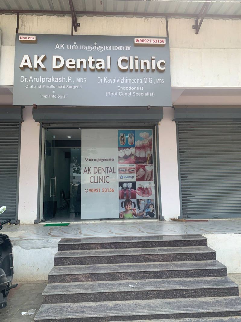 AK Dental Clinic board showing Dr. Arulprakash P and Dr. Kayalvizhimeena M G, MDS